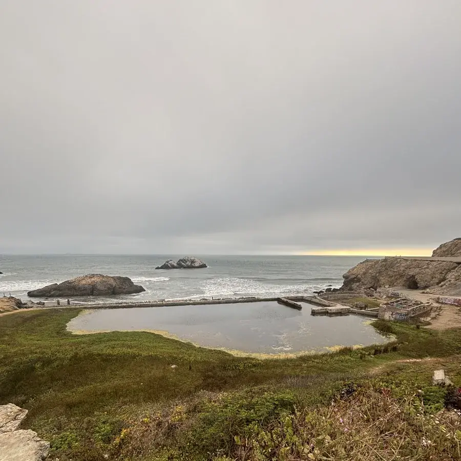 Sutro Baths below a foggy Pacific sunset